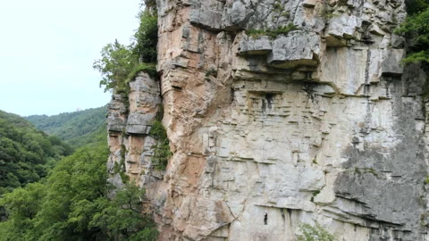 Climber climbs a mountain. Aerial shoot Stock Footage 152554576