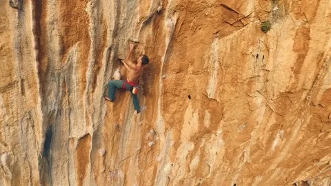 Climber climbs on rock bottom using insurance Stock Footage 71828051