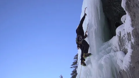 Climber in crampons using ice axes to climb on snowy mountain in slow motion Stock-Footage 73626670
