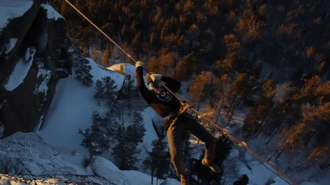 Climber crossing the gorge on sunset. Stock Footage 83674018