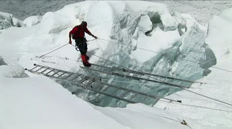 Climber crossing large  ladders Stock Footage 22180559