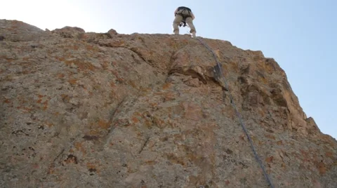 Climber descends with rock Video stock 63213374