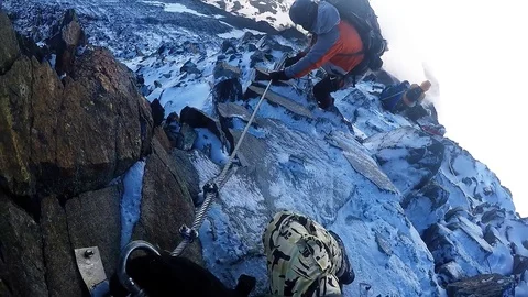 Climber down a cliff on a rope Stock Footage 115840509