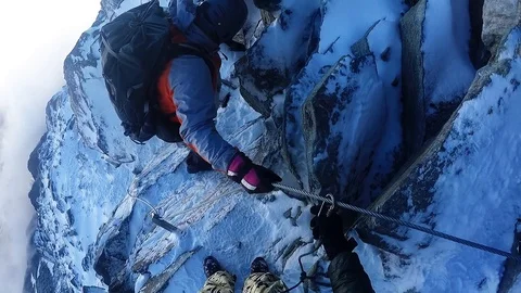 Climber down a cliff on a rope Stock Footage 115840610
