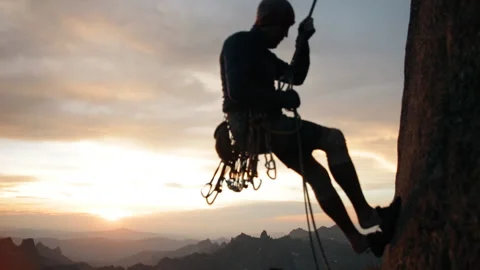 Climber down the mountain on a rope. Soft focus. Video stock 92035266