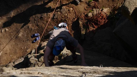 The climber falls off the cliff but the insurance pulls him out Stock Footage 128333552
