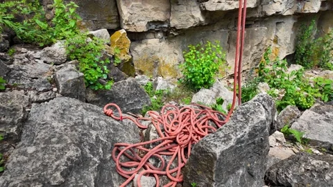 Climber finishing the descent down a steep cliff during an outdoor rock Stock Footage 345554227