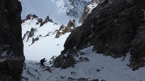 Climber goes down the gorge during strong wind Stock Footage 71532436
