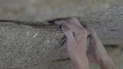 Climber gripping small edge on rock face Stock Footage 300551981