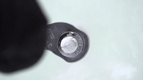 Climber hand inserting an ice screw while climbing on snowy mountain 動画素材 73623686