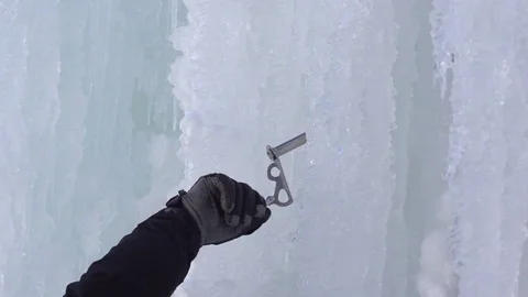 Climber hand inserting an ice screw while climbing on snowy mountain 動画素材 73626471
