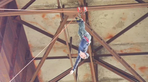 Climber hanging upside down, descending on a rope Stock Footage 60442887