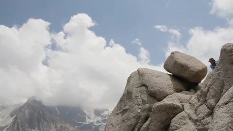 Climber has conquered peak among clouds Stock Footage 79682209