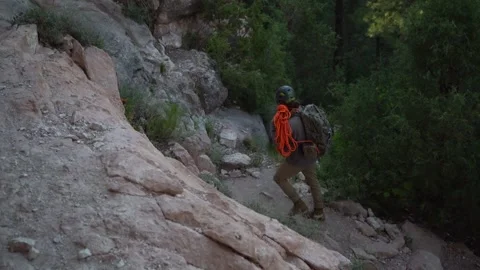 A climber heading to the rocks with his rope and equipment Stock Footage 279406105