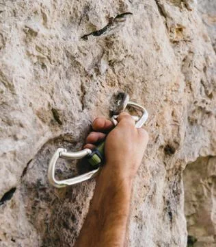 Climber holding a quick-draw Stock Photos