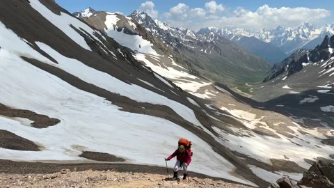Climber with a large backpack walks along a mountain path Stock Footage 135515770