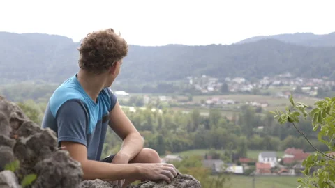 Climber looking at the distance on the top of the local mountain top Stock Footage 208933308