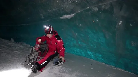 The climber made a halt inside an ice cave. Video stock 234449773
