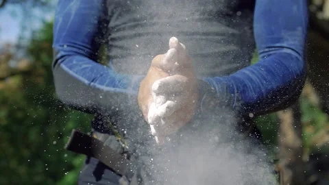 Climber man clap his hands with magnesium. Slow Motion Stock Footage 138689854
