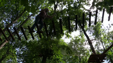 Climber move the ladder trees stretched in the amusement rope park. Time lapse. Stock Footage 39003410