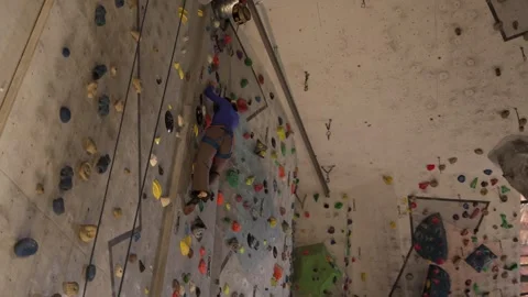 Climber moves steadily on high wall Stock Footage 339287804