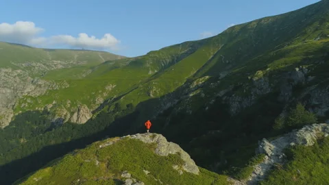 Climber with orange jacket hiking on rocky edge in Balkan mountains Stock Footage 158534166
