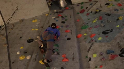Climber practices efficient movement on an indoor wall. Stock Footage 339287802