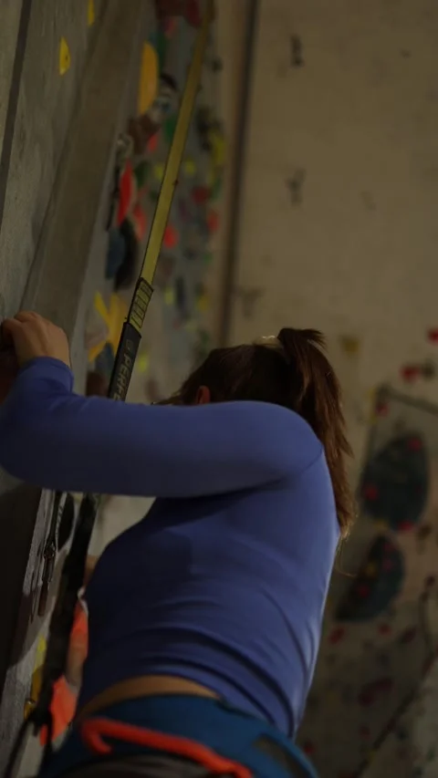 Climber practices technique on an indoor wall Stock Footage 339287690