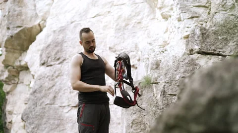 Climber preparing for rock climb Stock Footage 152556044