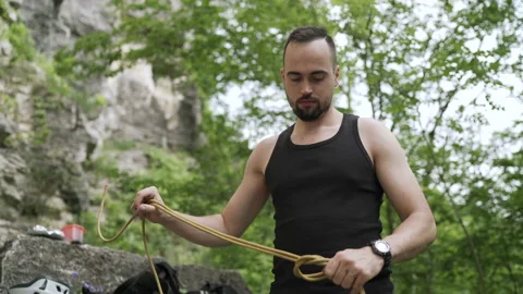 Climber preparing for rock climb Stock Footage 152556084