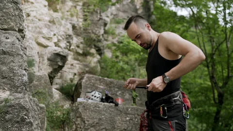 Climber preparing for rock climb Stock Footage 152556428