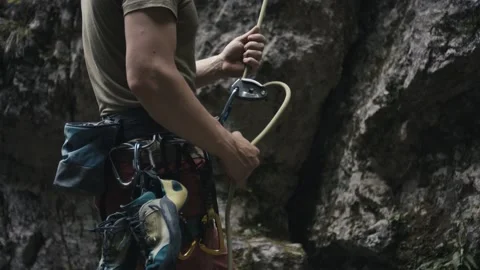 Climber protect rock climb partner pull brake by hand belay rope Stock Footage 134199722