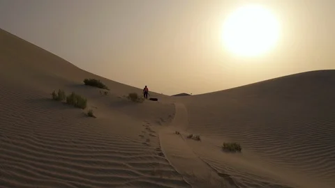 Climber pulling a tire in the desert at sunrise Stock Footage 122014744
