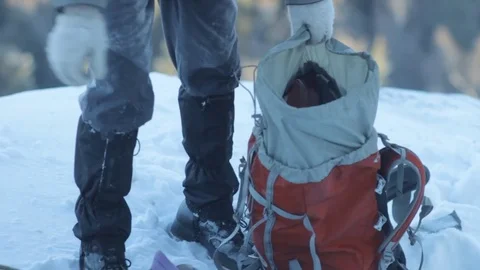 The climber pulls the gear out of the backpack 스톡 동영상 83675004
