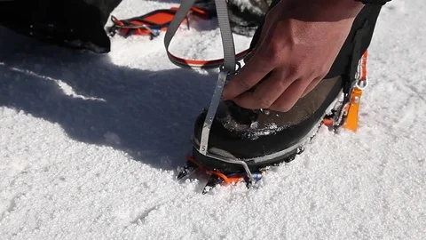 Climber puts on crampons (mountains, ice) Stock Footage 83676365