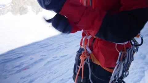 A climber puts on his gloves and ties his coat to climb mountains, Alps, France Stock Footage 240422109