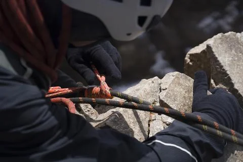 Climber is rappeling from the mountains summit. Stock Photos