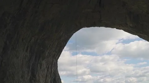 Climber Rappelling in Free Hang Beside Massive Mountain Cliff Face Vídeo Stock 345632308