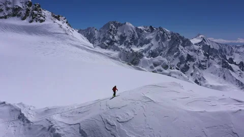 Climber in a red siut walking Up. Mountain Expedition Beautiful Peak Stock Footage 200498728
