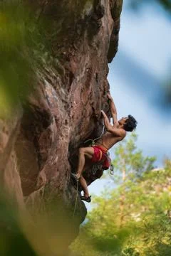 Climber on red wall Stock Photos