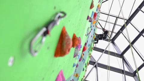 A climber rests on a climbing wall. Stock Footage 300503596