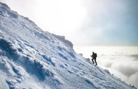 A climber rises above the clouds on Mt. Ngauruhoe, New Zealand Stock Photos