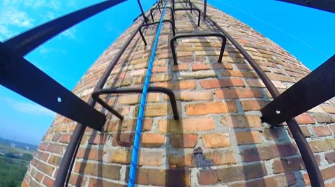 Climber rises on factory chimneys looking up and down Stock Footage 42417258