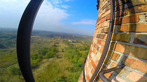 Climber rises on factory chimneys looking in different directions Stock Footage 42417616