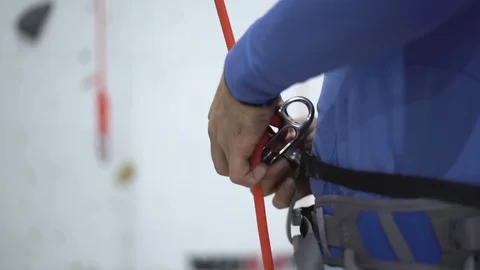 Climber setting equipment with ropes prepare for practice on indoor climbing Stock Footage 123213404