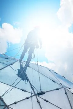 Climber on a skyscraper Stock Photos