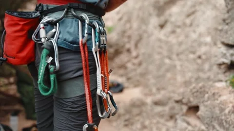 Climber Sorting Quickdraws on Harness at Rock Wall Stock Footage 346496385