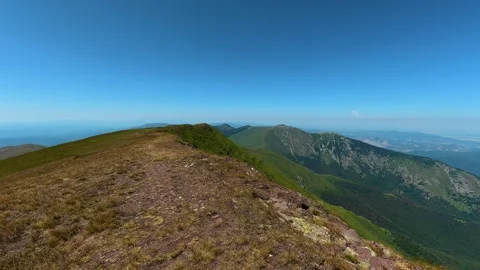 Climber stands atop mountain ridge, breathless. Balkan Mountains Serbia Stock Footage 344538544