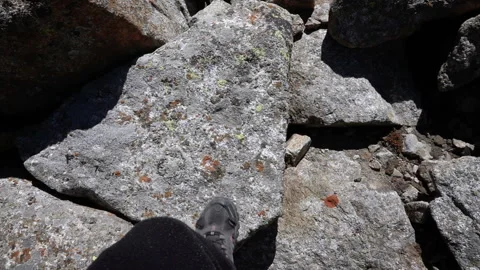 The climber steps on the rocks to climb up Stock-Footage 103967209