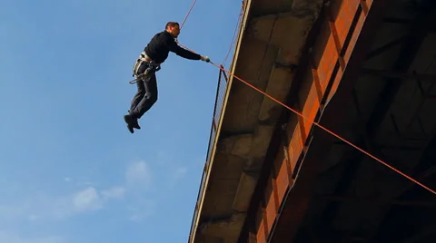 Climber swinging on the bridge Stock Footage 38041428